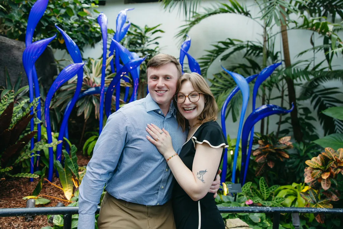 Just engaged at the Franklin Park Conservatory, in front of blue glass sculptures.